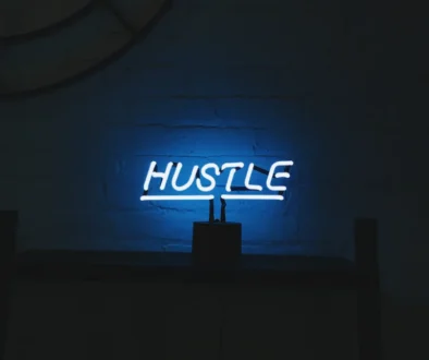 word hustle in bright lights