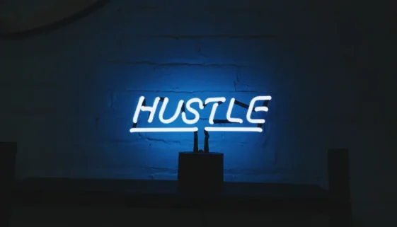 word hustle in bright lights